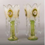 A pair of decorative glass lustres, with transfer print portrait panels and green and gilt