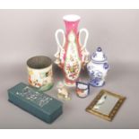 A mixed group lot to include Hummel figure, ornate ceramic vase, small brass framed mirror etc.