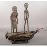 Two African wood carvings along with wooden a model boat. Wooden boat for restoration.