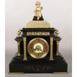 A Victorian slate and gilt metal mantel clock. Surmounted by a bacchanalian putti, with Classical