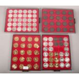 Four Lindner coin collectors cases filled with white yellow and bronze reproduction European coins