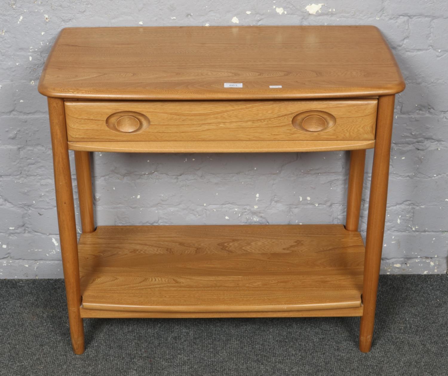 A golden dawn Ercol two tier side table with drawer. Minor scratches to under tier.