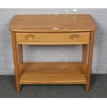 A golden dawn Ercol two tier side table with drawer. Minor scratches to under tier.