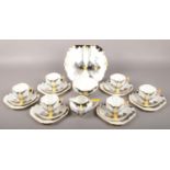 A Shelley Queen Anne six part bone china teaset in the Sunrise and Tall Trees design. No chips,