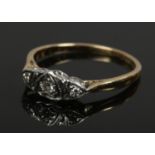 A ladies 18ct and platinum three stone diamond ring, size P 2.44 grams.
