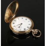 A rolled gold Cyma full hunter pocket watch with subsidiary dial and roman numeral markers.