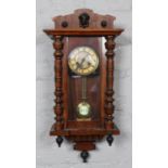 A mahogany cased eight day wall clock by Kienzle Germany, chiming on a coiled gong. Scuffs to case.