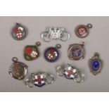 A collection of cycling club badges and medals including enameled examples.