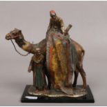 After Franz Bergman, a cold painted Spelter table lighter formed as a camel and two rug sellers.