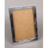 A George V silver mounted rectangular easel photograph frame on oak back. Assayed Birmingham 1917,