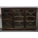 A large astrigal glazed mahogany bookcase. In need of restoration, missing glass, badly damaged to