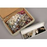 A leather jewellery box containing various costume jewellery items including Pinchbeck cameo brooch,