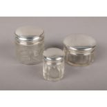 Three silver top glass jars to include assayed Birmingham 1942 example etc.