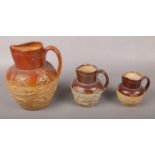 Three c19th graduated salt glazed stoneware jugs with sprig moulded decoration.