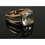 A 9ct gold dress ring with split shoulders and set with a square faceted prasiolite. 5.6 grams, size