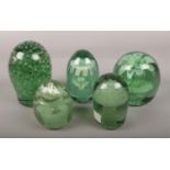 Five Victorian green glass dumps, to include bubble effect and floral designs. (Tallest 13.5cm,