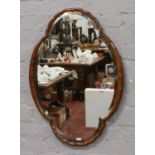 A mahogany framed oval mirror.