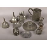 A collection of pewter to include capstan inkwell, tankard, funnels etc.