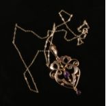 An early 20th century 9ct gold and amethyst openwork pendant on trace chain, 2.1 grams. Good