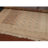 A Persian cream ground wool carpet with central diamond panel decoration, approximately 380cm x