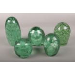 Five Victorian green glass dumps, to include bubble effect and floral designs. (Tallest 15cm,