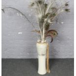 A Large ceramic vase (61cm High 15cm wide) with peacock feathers