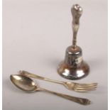 A silver bell, assayed Birmingham 1904 by Crisford & Norris Ltd. along with a silver fork and spoon,