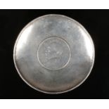 A 20th century Chinese planished silver dish set with a Republic silver dollar, 64 grams, 9cm