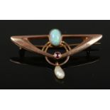 A 9ct gold bar brooch with opal and ruby and a pearl drop by Murrle Bennet & Co. Marked to the back,