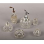 Two silver top glass scent bottles along with 4 silver top glass salts.