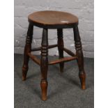 A oak stool with turned support