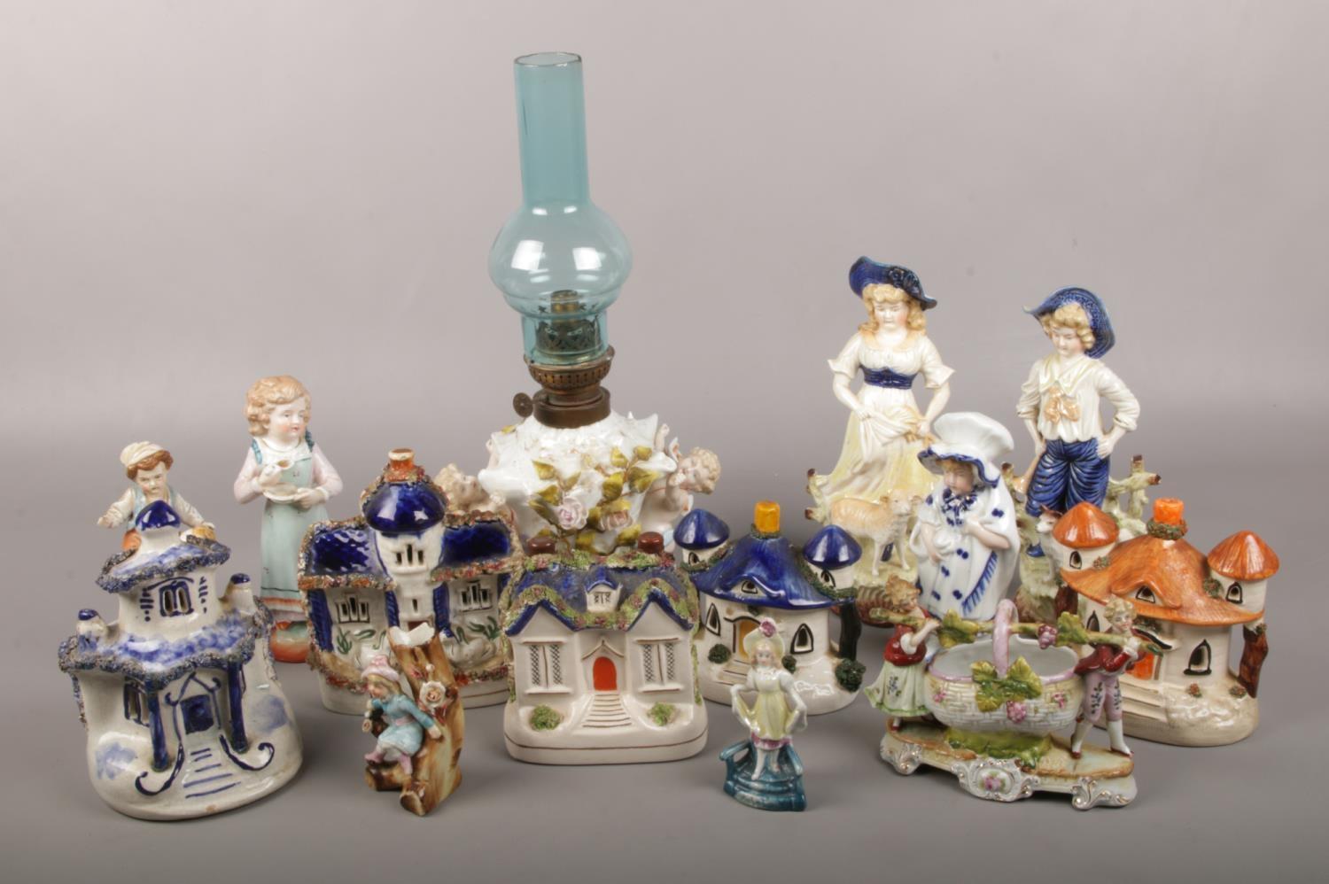 A group of ceramics to include, cherub oil lamp, pastille burners, figures etc. Oil lamp repaired.