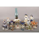 A group of ceramics to include, cherub oil lamp, pastille burners, figures etc. Oil lamp repaired.
