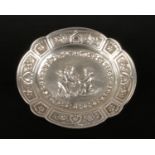 A Continental lobed silver pin dish. Embossed with a pair of winged cherubs under a rose border.