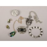 A small collection of costume jewellery including an iridescent pendant and earring suite, pewter