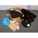 A box of clothes to include leather jacket, fur coat, hats, gloves etc
