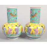 A pair of early 20th century Japanese porcelain mantel vases, each decorated with figures and