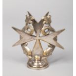 A 1920s silver plated car mascot of Maltese cross form. Surmounted by a pair of coiled dolphins.