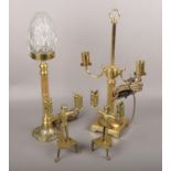 A pair of figural brass candlesticks along with two brass tables lamps to include cut glass shade