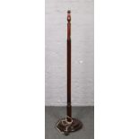 A mahogany standard lamp with reeded and turned column.