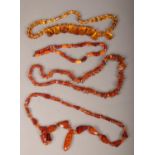 Four amber necklaces including butterscotch beads and inclusions.