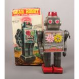 A tin plate gear robot, visible gears mechanism, wind up with stopper in original box No rust.