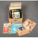 A box of LP records, mainly pop and easy listening.