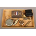 A box of collectables including a sovereign case, Barker & Sons compass, pocket knives and a