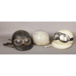 Three vintage motorcycle pudding basin helmets including Lycett, Geno and Aviakit. Two with goggles.