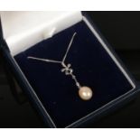 A silver, cultured pearl and diamond drop pendant on chain.