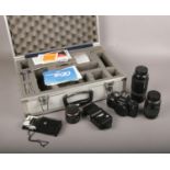 A cased Praktica Bx20 35mm camera, along with three lenses, flash etc.