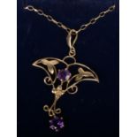 A 9ct gold and amethyst Art Nouveau style pendant on trace chain, 2.5 grams gross.