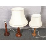 A collection of wooden table lamps with shades