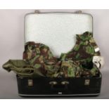 A vintage suitcase containing army combat clothing, two combat trousers size 01, 80, two Smock